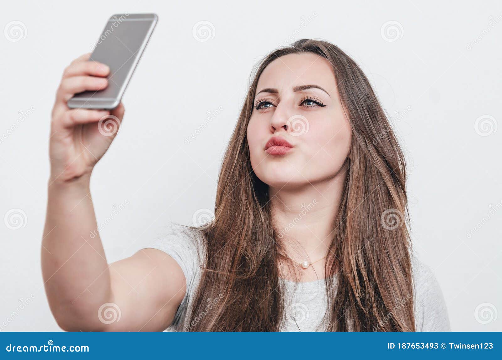 A Woman Taking A Selfie With Her Cell Phone In Front Of A Ceiling Fan A Woman Taking A Selfie With Her Cell Phone In Front Of A Ceiling Fan
